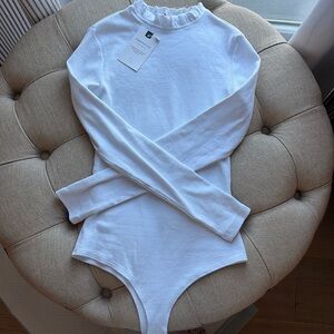Ruffle neck ribbed white long sleeve bodysuit